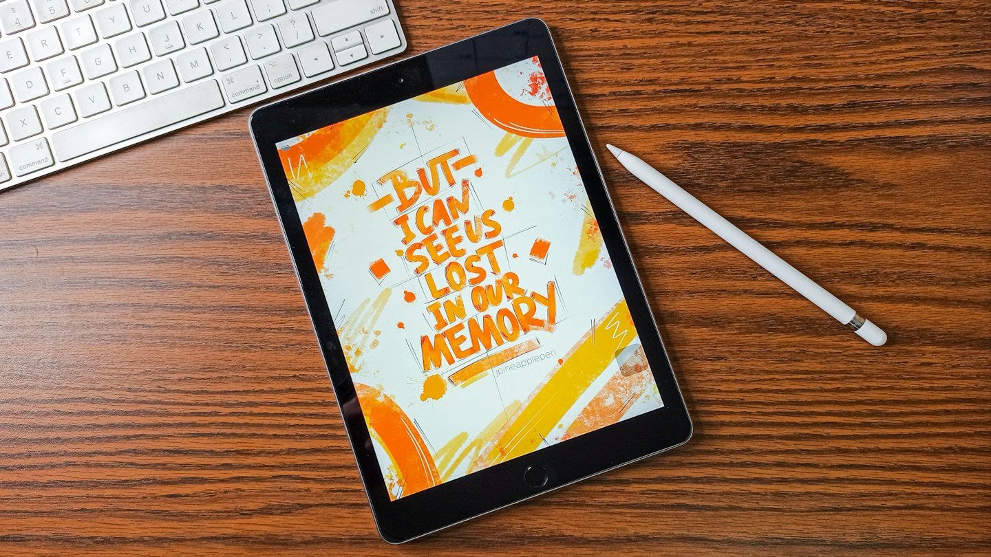 Tablet with digital art on a wooden desk with stylus and keyboard.
